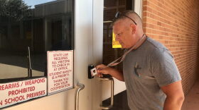Moore Public Schools Superintendent Robert Romines demonstrates the district’s new building entry system.