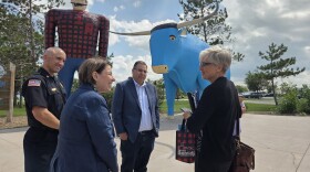 U.S. Sen. Amy Klobuchar, front left, visits with a staffer in front of Paul Bunyan and Babe the Blue Ox with Bemidji Fire Chief Justin Sherwood, back left, and Mayor Jorge Prince, center, on July 25, 2025.