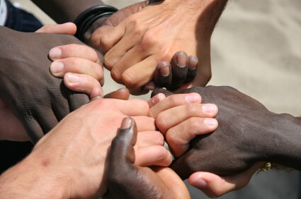 Black and white hands joined together