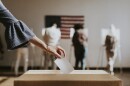 American casting her vote to a ballot box