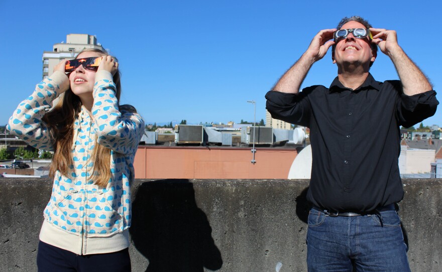 John Sullivan, who oversees IT for KUOW, with his daughter on the KUOW garage roof.