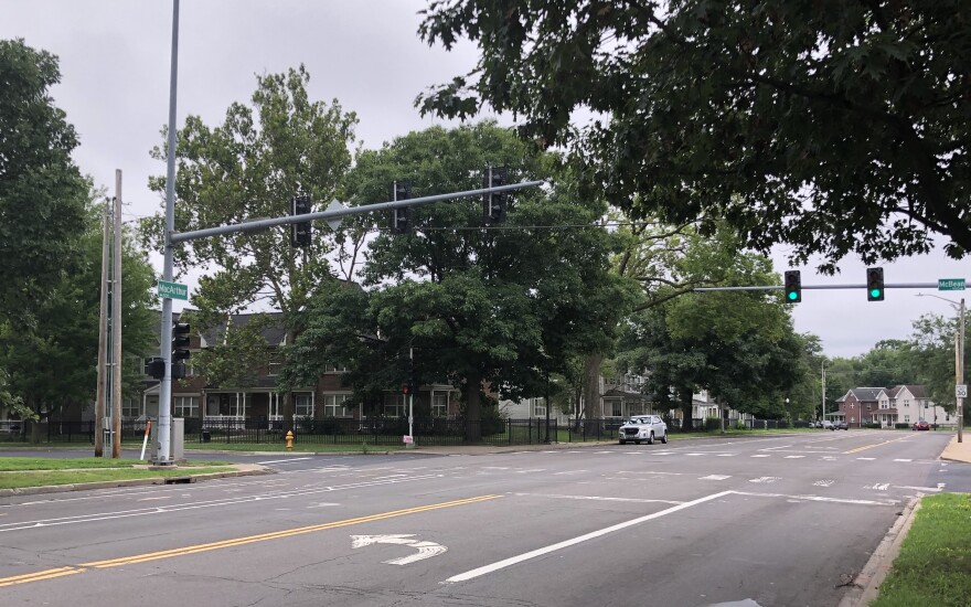 Trees hover over MacArthur Highway on Peoria's South Side as the traffic signal over the southbound lanes at the McBean Street intersection gives the green light to vehicles on the highway.
