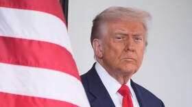 President Donald Trump waits to greet Argentina's President Javier Milei, as he arrives at the White House, Tuesday, Oct. 14, 2025, in Washington. (AP Photo/Mark Schiefelbein)