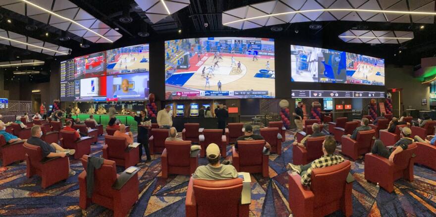 Sports fans, almost all of them men, filled up nearly all the seats at the Harrah’s Cherokee Casino sports book on Thursday, the first day it was open to accept sports bets. Many were enthused about the play-in games on the first night of the NCAA Tournament.