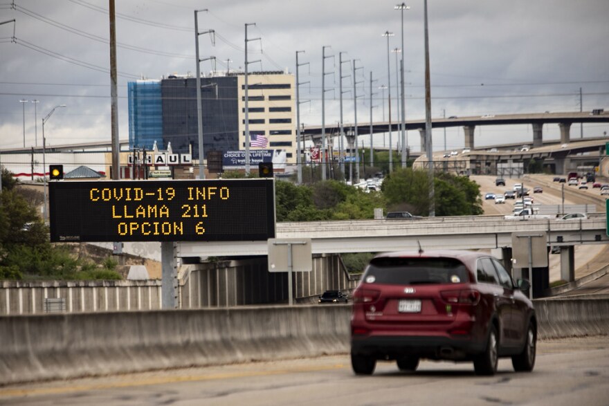 A sign tells Spanish speakers to dial 211 for information about the coronavirus.