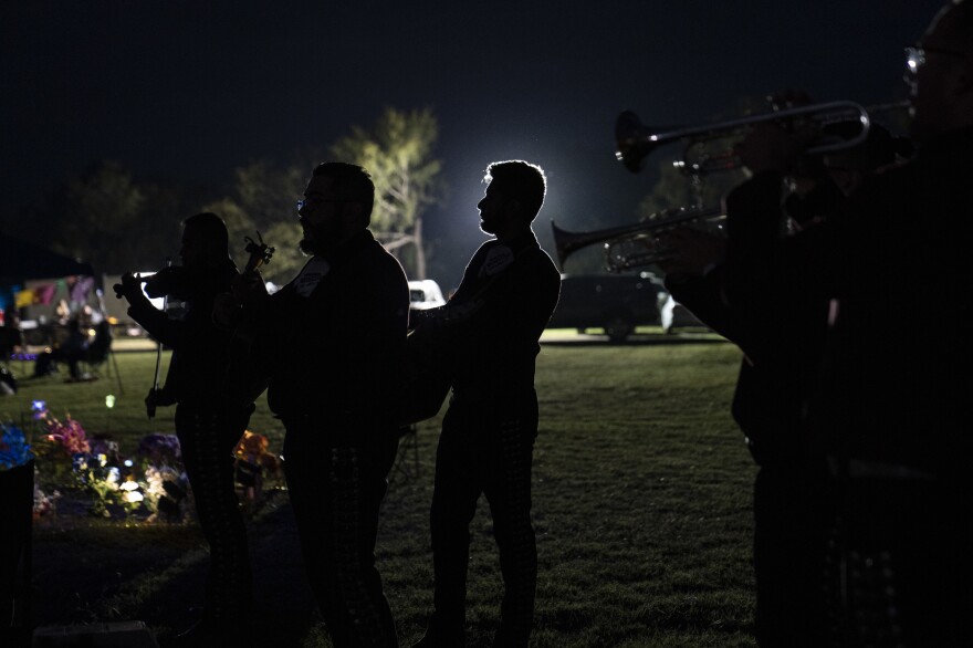 A mariachi group plays during Day of the Dead at Hillcrest Memorial Cemetery.