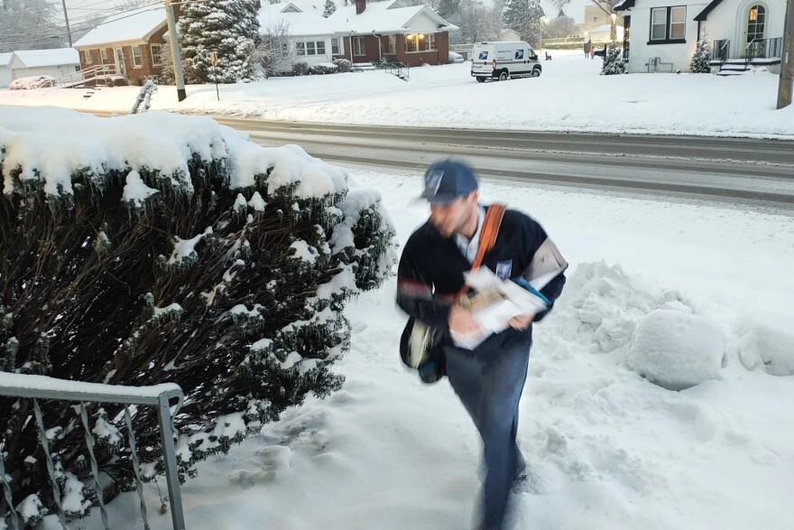 USPS Letter Carrier Stephen Sing makes his way across the ice encrusted sidewalks of Bellemeade Avenue in Evansville in early January. City letter carriers have worked without a new contract since May of 2023.