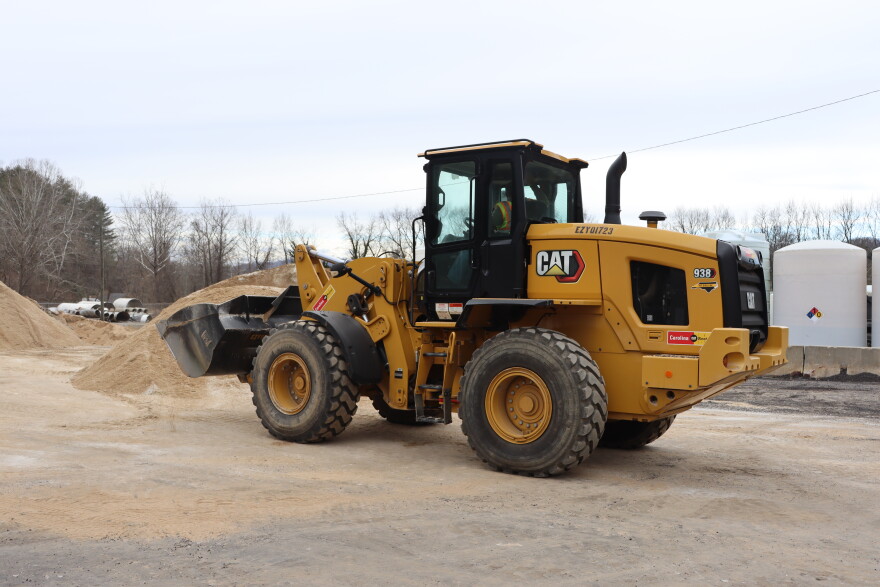 A shovel truck mixes salt and sand at a NCDOT staging center ahead of this weekend's winter storm.