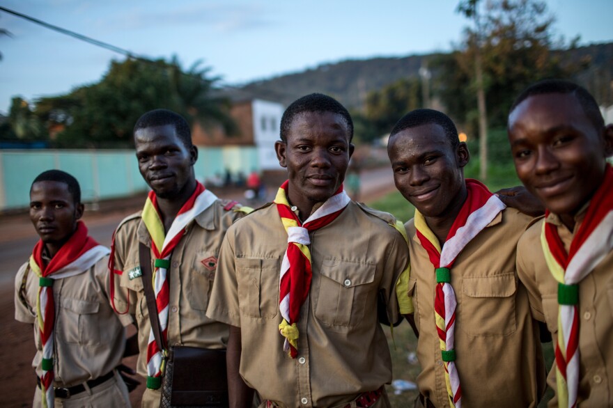Members of the Flambeaux group of scouts, who have been engaged to act as security at an event, stand outside Le Complexe Scolaire International Galaxy in Bangui.