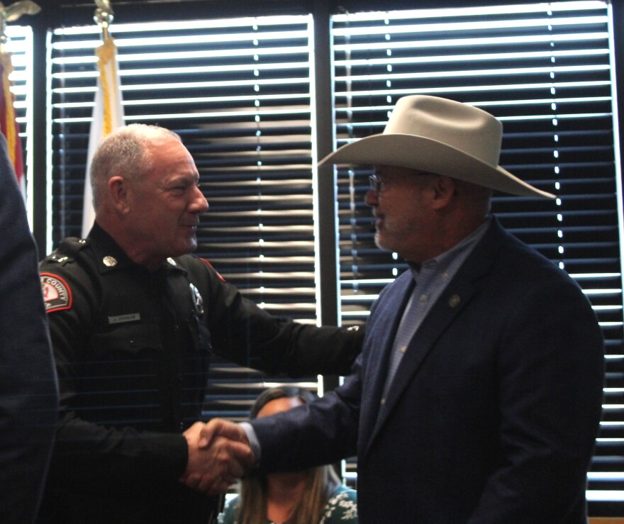 Interim Greene County Sheriff Jason Johnson shakes hands with former Greene County Sheriff Jim Arnott.