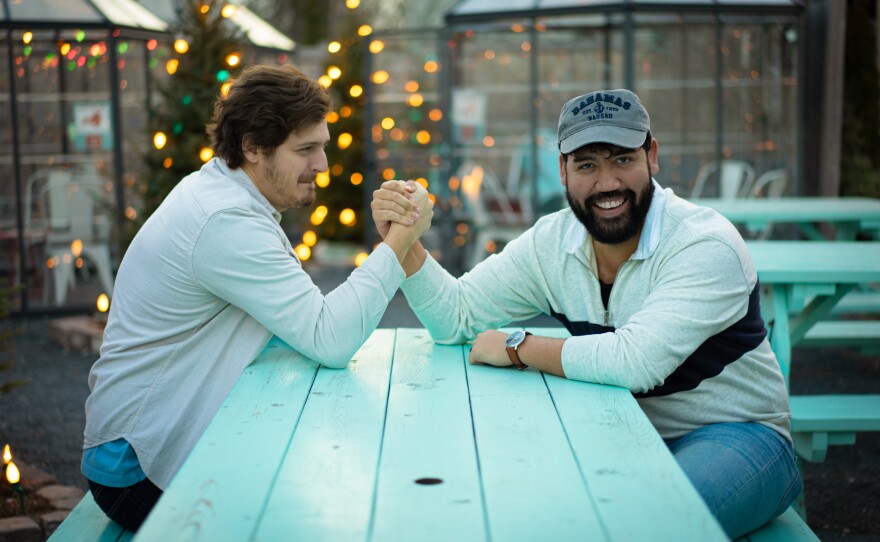 Picture of couple playfully arm wrestling 