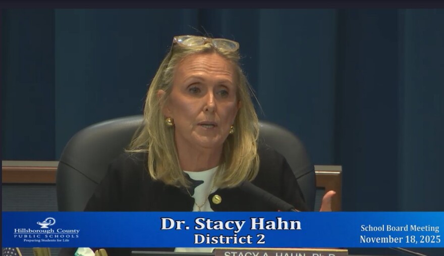 A blond woman with glasses on her head