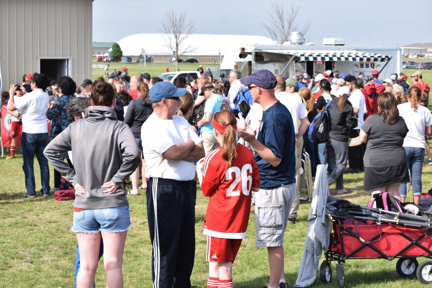 Large group of soccer players and families crowd an area near a food truck at Community Fields along Ireland Grove Road in Bloomington.