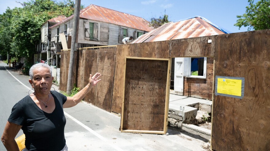 Frandelle Gerard, Crucian Heritage and Nature Tourism Inc. executive director, discusses a preservation training program the nonprofit organization offers that is working with trainees to renovate historic buildings on Hospital Street in the Free Gut area of Frederiksted, including two homes pictured.