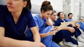 Female nurse examining medical records in the corridor