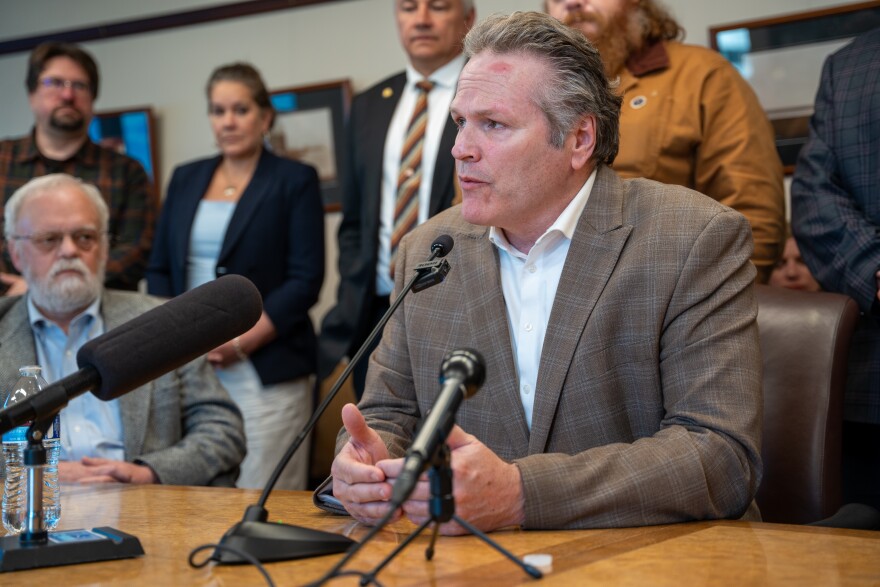 Gov. Mike Dunleavy, flanked by members of the Republican minority caucuses in the state House and Senate, speaks at a news conference on July 16, 2026.