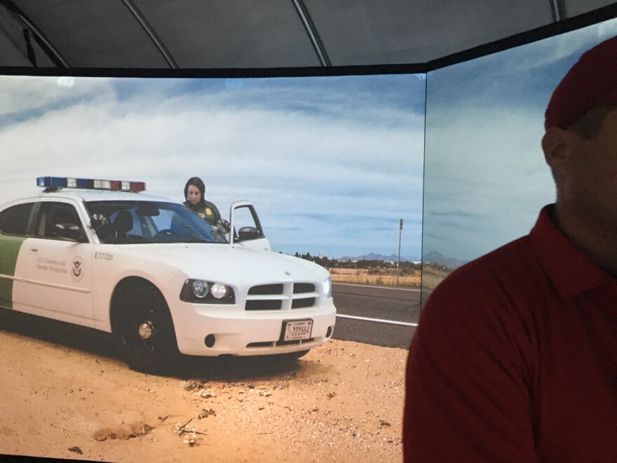 A Border Patrol agent is displayed on the agency's training simulator during an exercise.