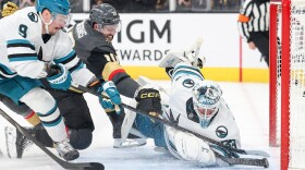 Vegas Golden Knights center Colton Sissons (10) scores a goal against San Jose Sharks defenseman Dmitry Orlov (9) and goaltender Alex Nedeljkovic (33) during the second period of an NHL hockey game Saturday, Nov. 29, 2025, in Las Vegas. (AP Photo/Ian Maule)