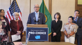 Washington Governor Jay Inslee speaks at a podium.