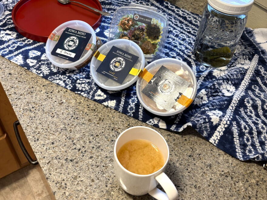 Hesselink currently sells three different miso varieties which vary based on fermentation length and choice of grains. A mug of miso tea is in the foreground.