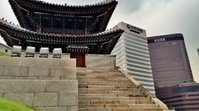 Traditional architecture and modern skyscrapers overlap in central Seoul.