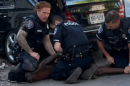Several police officers hold down Kareem Franklin, 23, during his arrest on Monday, June 8.