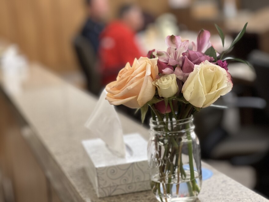 The family placed a vase of flowers at the edge of the courtroom, next to box of tissues that was well-used during the hearing.
