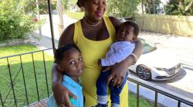 Javier stands with his mother and new baby brother. They arrived in Massachusetts in May and Javier is eager to start kindergarten.  (Gabrielle Emanuel/WBUR)