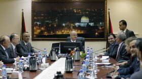Palestinian Prime Minister Rami Hamdallah (center) leads the first Cabinet meeting of the new Palestinian unity government in the West Bank city of Ramallah on Tuesday.