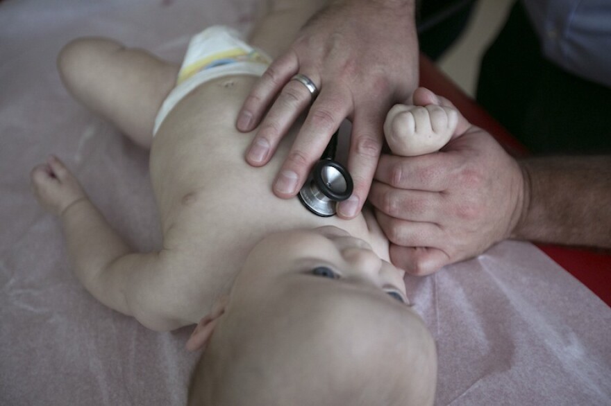 Dr. RJ Gillespie examines four-month-old Payton Pike at The Children’s Clinic in Portland, September 3, 2015.