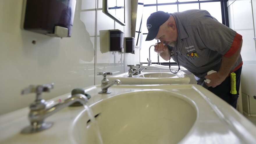 Al Jones of the West Virginia Department of General Services tests water as he flushes faucets and opens a rest room at the State Capitol in Charleston, W. Va., on Jan. 13, four days after a chemical spill into the Elk River. It wasn't until Jan. 21 that state officials were told by Freedom Industries that a second contaminant had also entered the river.