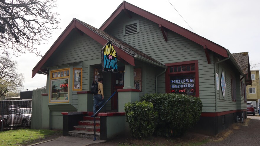 A customer walks into Eugene's House of Records on April 7, 2026. The business has called this converted house its home since 1973.