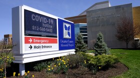 A COVID-19 hot line number is posted outside of Decatur County Memorial Hospital, Thursday, April 2, 2020, in Greensburg, Ind. Three southeast Indiana counties have among the highest per-capita coronavirus infection rates in the country.