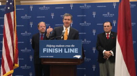 Governor Roy Cooper announced the Finish Line Grants Program from the campus of Wake Technical Community College. He is flanked by the state community college President Peter Hans on his left, and Wake Technical Community College President Stephen Scott.