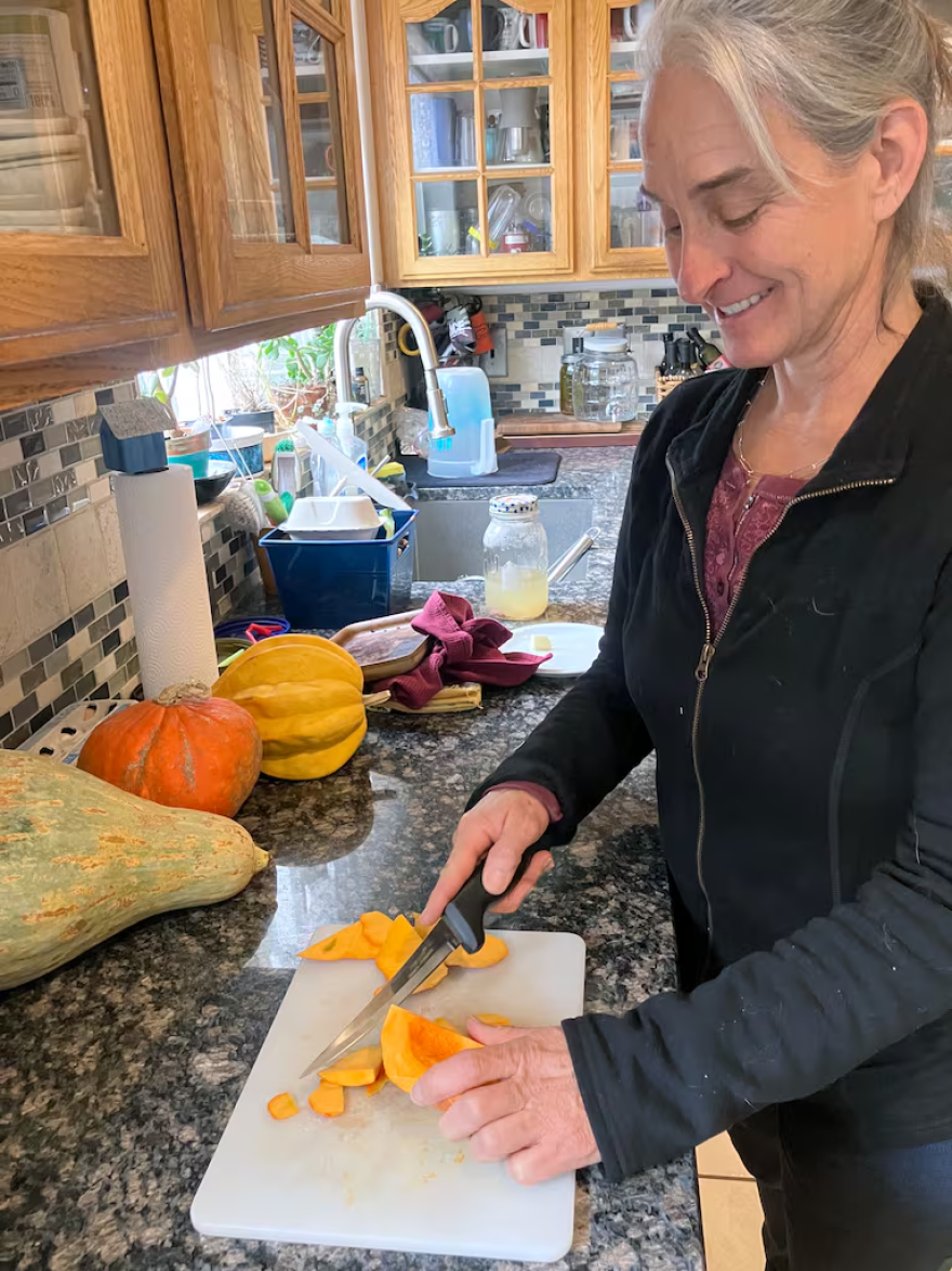 Anne Christmas chops squash.