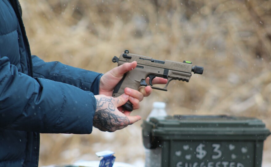Emma Oaks, a 28-year-old queer woman from Columbus, practices shooting with Liberal Gun Club Instructor Matt Shepherd.