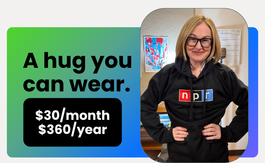 a white woman wears a dark gray sweatshirt with the NPR logo on it