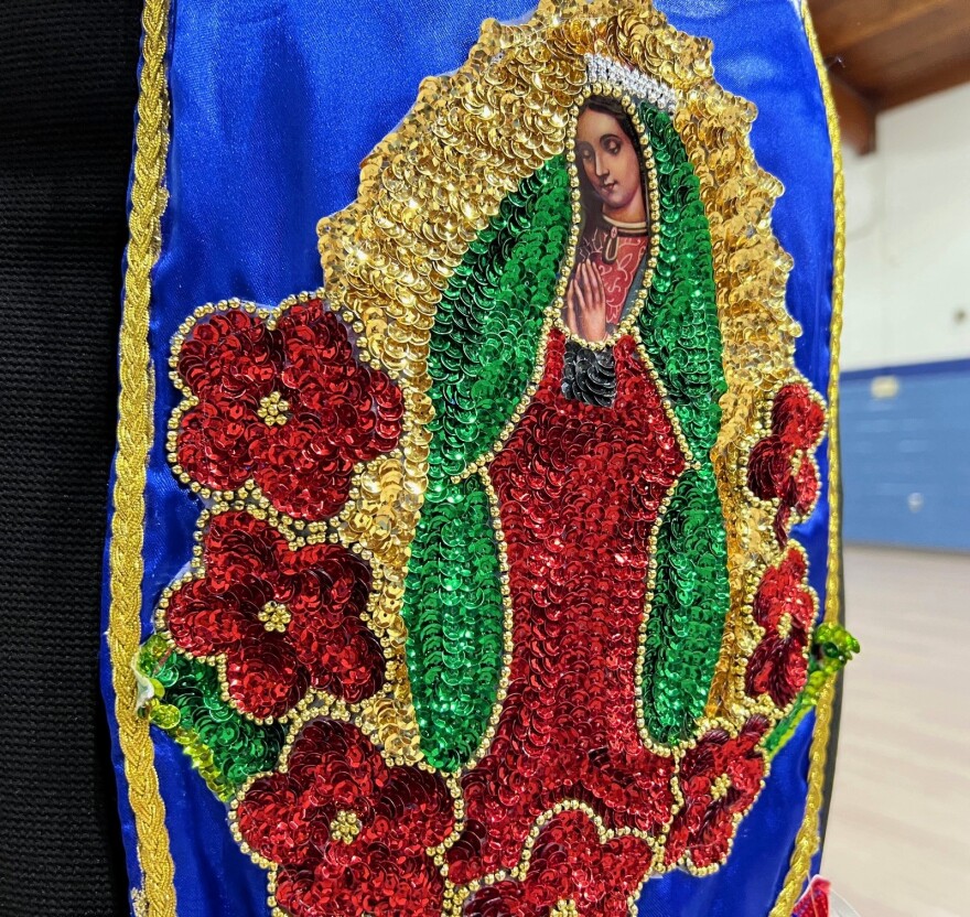 An image of the Virgin Mary is made of beads and sequence. 