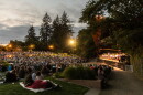 A crowd watches a performance by the Eugene Symphony at Cuthbert Amphitheater