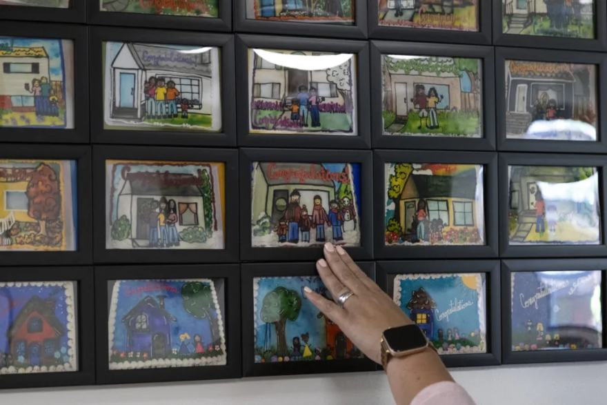 The “cake wall” at Family Promise shows family photos as cake illustrations to remember those who have completed the program while preserving their anonymity.