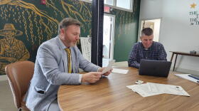 State Assemblymember Pat Burke, left, reviews documents with staff members at his office.