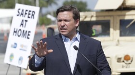 Florida Gov. Ron DeSantis speaks during a news conference at a drive-through coronavirus testing site in front of Hard Rock Stadium, Monday, March 30, 2020, in Miami Gardens, Fla.