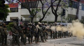FILE - Border Patrol personnel deploy tear gas during a demonstration over the dozens detained in an operation by federal immigration authorities a day earlier, in Paramount, Calif., June 7, 2025.