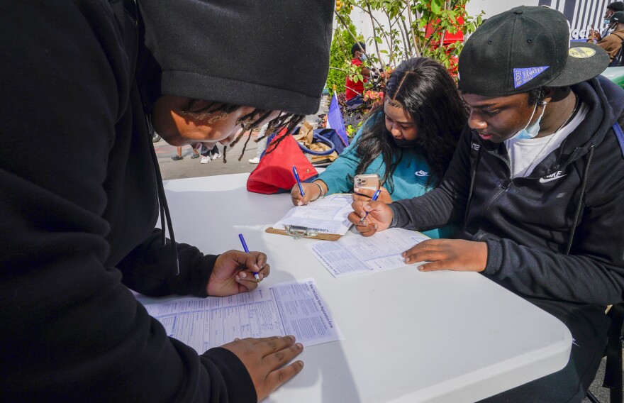 Residents of Brooklyn's Flatbush neighborhood register to vote at a voter registration event on Sept. 29, 2021.