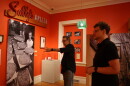 Filmmaker Gorman Bechard (left) discusses the Sally’s Apizza exhibit with New Haven Museum curator Jason Bischoff-Wurstle (right).