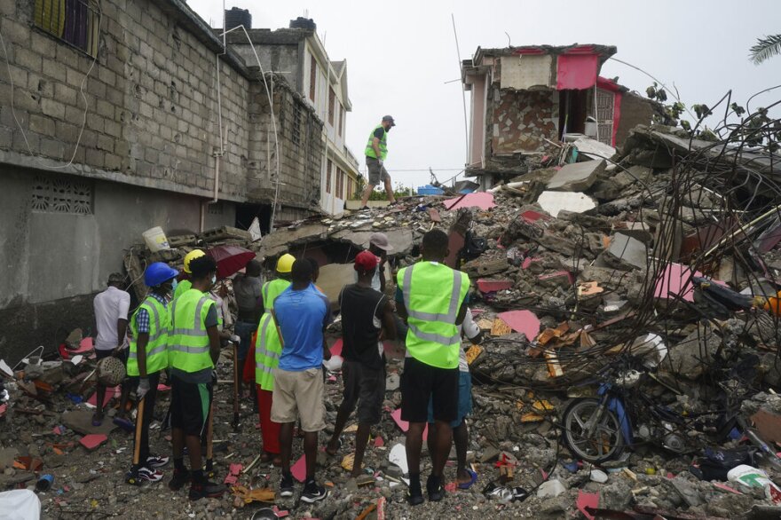Canadian volunteer Randy Lodder walks over debris on August 17, 2021,as he helps search for people who may be trapped under the earthquake rubble.