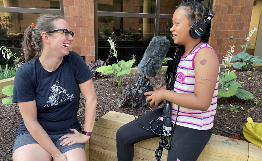 Kids are welcome at most Enterprise events. Here, reporter Lindsey Smith teaches a young attendee to use a recorder.