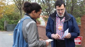 Orange County Democratic volunteer Paul Brinich explains the details of a Democratic sample ballot to UNC Chapel Hill student Ashaki George before George enters Chapel Hill First Baptist Church voting site to vote.