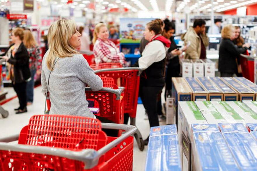 Shoppers wait in line for Apple iPhone purchases during a Black Friday sale at a Target store, Friday, Nov. 23, 2018, in Newport, Ky.