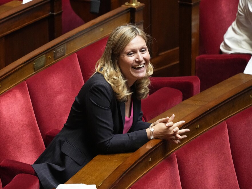 Yaël Braun-Pivet, a member of the centrist alliance Ensemble (Together) smiles at the National Assembly, Tuesday, June 28, 2022 in Paris. France's lower house of parliament opened its first session since President Emmanuel Macron's party lost its majority, and elected a woman, Yael Braun-Pivet, as speaker for the first time. (AP Photo/Michel Euler)